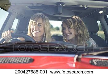 Stock Photography - young women in 
car, smiling, 
close-up, view 
through car windscreen. 
fotosearch - search 
stock photos, 
pictures, images, 
and photo clipart