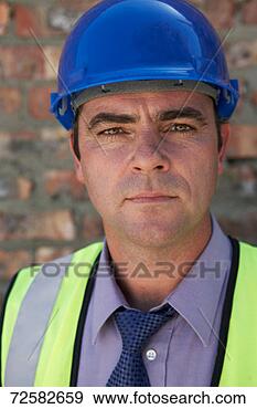 Stock Photograph - professional man 
on building site 
wearing hard hat, 
portrait. fotosearch 
- search stock 
photos, pictures, 
images, and photo 
clipart