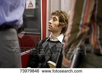 Stock Photo - young man sitting 
in subway train. 
fotosearch - search 
stock photos, 
pictures, images, 
and photo clipart
