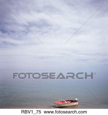 Stock Image - a red and white 
beached fishing 
boat sits on the 
sand of a blue 
ocean. fotosearch 
- search stock 
photos, pictures, 
images, and photo 
clipart