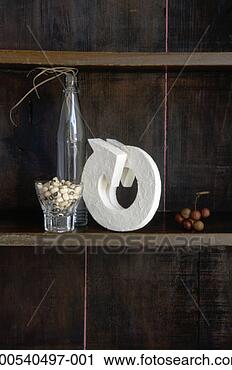 Stock Photography - arrow, glass bottle, 
nuts and black-eyed 
peas on wooden 
shelf. fotosearch 
- search stock 
photos, pictures, 
images, and photo 
clipart