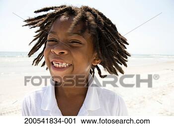 Stock Photography - boy (6-8) shaking 
head on beach, 
portrait (blurred 
motion). fotosearch 
- search stock 
photos, pictures, 
images, and photo 
clipart
