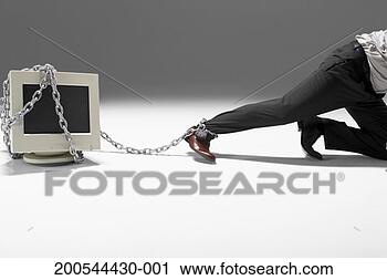 Stock Photography - businessman chained 
to computer monitor, 
crawling away, 
studio shot. fotosearch 
- search stock 
photos, pictures, 
images, and photo 
clipart