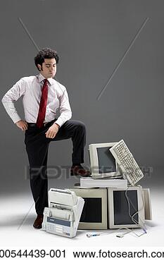 Stock Photography - businessman conquering 
old technology, 
studio shot. fotosearch 
- search stock 
photos, pictures, 
images, and photo 
clipart