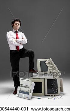 Stock Photography - businessman conquering 
old technology, 
studio shot. fotosearch 
- search stock 
photos, pictures, 
images, and photo 
clipart