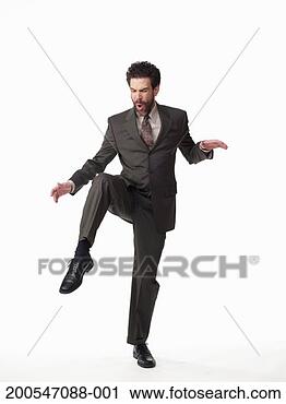 Stock Photography - businessman standing 
on one leg, on 
white background, 
portrait. fotosearch 
- search stock 
photos, pictures, 
images, and photo 
clipart