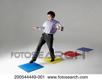 Stock Photography - businessman stepping 
across puzzle 
pieces, studio 
shot. fotosearch 
- search stock 
photos, pictures, 
images, and photo 
clipart