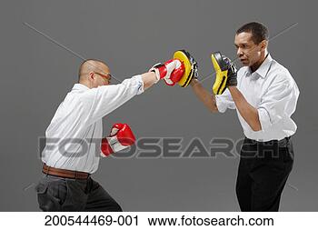Stock Photography - businessmen boxing, 
studio shot. fotosearch 
- search stock 
photos, pictures, 
images, and photo 
clipart
