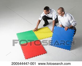 Stock Photography - businessmen connecting 
puzzle pieces, 
studio shot. fotosearch 
- search stock 
photos, pictures, 
images, and photo 
clipart