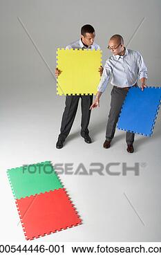 Stock Photography - businessmen holding 
puzzle pieces, 
problem solving, 
studio shot. fotosearch 
- search stock 
photos, pictures, 
images, and photo 
clipart