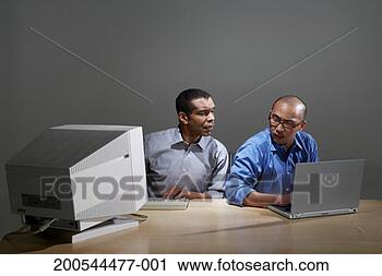 Stock Photography - businessmen using 
old and new computer 
technology. fotosearch 
- search stock 
photos, pictures, 
images, and photo 
clipart