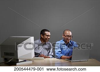 Stock Photography - businessmen using 
old and new computer 
technology. fotosearch 
- search stock 
photos, pictures, 
images, and photo 
clipart