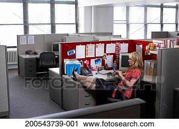 Stock Photography - businesswoman 
in office cubicle 
with feet on desk. 
fotosearch - search 
stock photos, 
pictures, images, 
and photo clipart