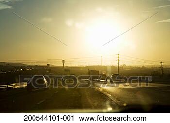 Stock Photography - cars on highway 
at sunset. fotosearch 
- search stock 
photos, pictures, 
images, and photo 
clipart