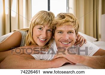 Stock Photography - 'couple lying 
together in bed, 
head and shoulders, 
portrait'. fotosearch 
- search stock 
photos, pictures, 
images, and photo 
clipart