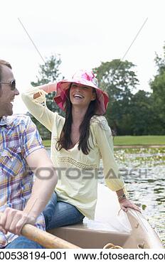 Stock Photography - couple in rowing 
boat on lake, 
woman smiling. 
fotosearch - search 
stock photos, 
pictures, images, 
and photo clipart