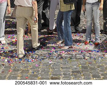 Stock Photography - crowd of people 
standing on coloured 
confetti in street, 
low section. fotosearch 
- search stock 
photos, pictures, 
images, and photo 
clipart
