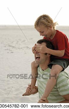 Stock Photography - father carrying 
son (6-8) on shoulders, 
laughing as son 
covers eyes. fotosearch 
- search stock 
photos, pictures, 
images, and photo 
clipart