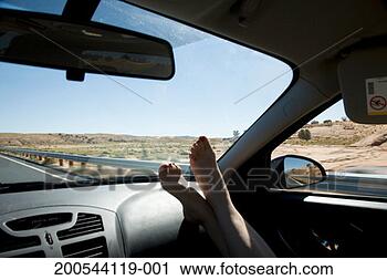 Stock Photography - feet on dashboard 
of car in desert. 
fotosearch - search 
stock photos, 
pictures, images, 
and photo clipart