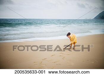 Stock Photography - girl (6-8) writing 
with stick on 
sand. fotosearch 
- search stock 
photos, pictures, 
images, and photo 
clipart