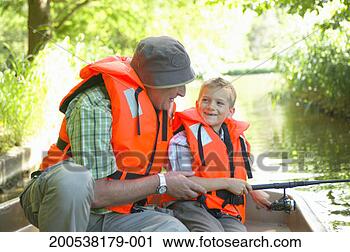 Stock Photography - grandfather and 
grandson (6-8) 
fishing from boat, 
smiling. fotosearch 
- search stock 
photos, pictures, 
images, and photo 
clipart
