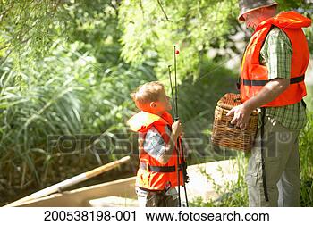 Stock Photography - grandfather and 
grandson (6-8) 
standing by boat 
with fishing rods. 
fotosearch - search 
stock photos, 
pictures, images, 
and photo clipart