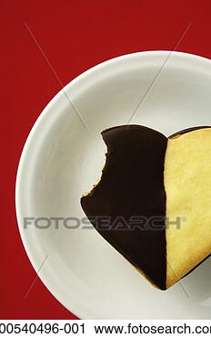 Stock Photography - heart-shaped cookie 
with bite missing, 
overhead view. 
fotosearch - search 
stock photos, 
pictures, images, 
and photo clipart