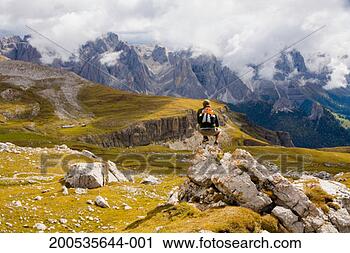 Stock Photography - italy, trentino-alto 
adige, alto adige, 
male hiker on 
rock, rear view. 
fotosearch - search 
stock photos, 
pictures, images, 
and photo clipart