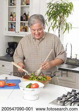 Stock Photography - man preparing 
salad in kitchen. 
fotosearch - search 
stock photos, 
pictures, images, 
and photo clipart