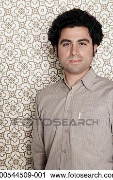Stock Photography - man smiling, against 
wallpaper background, 
portrait. fotosearch 
- search stock 
photos, pictures, 
images, and photo 
clipart