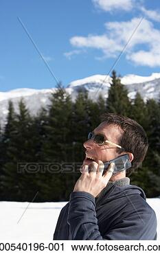 Stock Photography - man talking on 
cell phone outdoors 
in snow, laughing, 
side view. fotosearch 
- search stock 
photos, pictures, 
images, and photo 
clipart