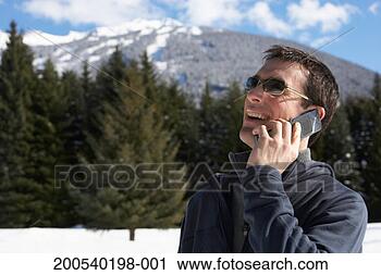 Stock Photography - man talking on 
cell phone outdoors 
in snow, laughing. 
fotosearch - search 
stock photos, 
pictures, images, 
and photo clipart