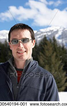 Stock Photography - man wearing sunglasses 
outdoors, mountains 
in distance, portrait. 
fotosearch - search 
stock photos, 
pictures, images, 
and photo clipart