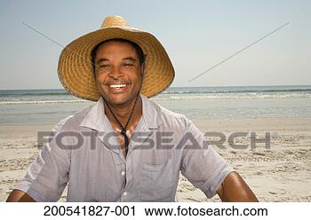 Stock Photography - mature man wearing 
sun hat on beach, 
smiling, portrait. 
fotosearch - search 
stock photos, 
pictures, images, 
and photo clipart