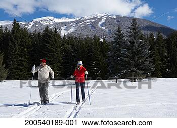 Stock Photography - mature man and 
woman cross-country 
skiing. fotosearch 
- search stock 
photos, pictures, 
images, and photo 
clipart