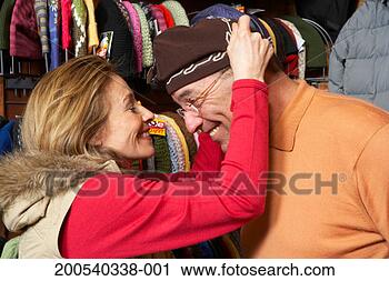Stock Photography - mature man and 
woman shopping 
for knit hats 
in retail store, 
side view. fotosearch 
- search stock 
photos, pictures, 
images, and photo 
clipart