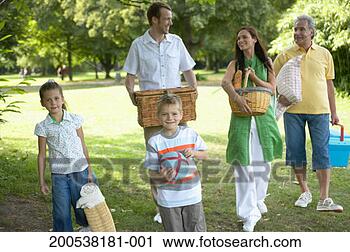 Stock Photography - multi-generational 
family carrying 
picnic things 
in park, smiling. 
fotosearch - search 
stock photos, 
pictures, images, 
and photo clipart
