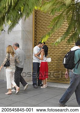 Stock Photography - people walking 
past young couple 
kissing in street. 
fotosearch - search 
stock photos, 
pictures, images, 
and photo clipart