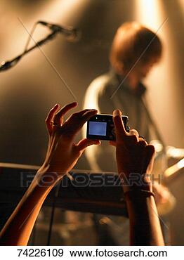 Stock Photograph - person photographing 
musician at concert. 
fotosearch - search 
stock photos, 
pictures, images, 
and photo clipart