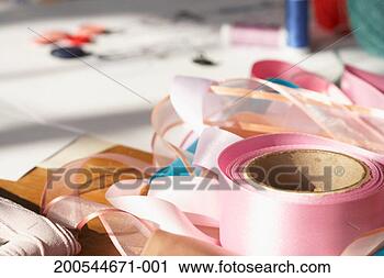 Stock Photography - rolls of ribbon 
on table, close-up. 
fotosearch - search 
stock photos, 
pictures, images, 
and photo clipart