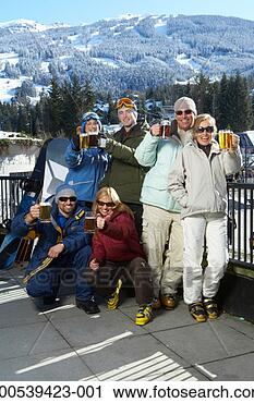 Stock Photography - six adults in 
ski-wear drinking 
beer on pub balcony 
beside mountain. 
fotosearch - search 
stock photos, 
pictures, images, 
and photo clipart