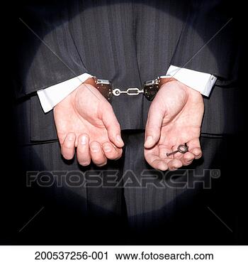 Stock Photography - spotlight on businessman 
with hands cuffed, 
holding key. fotosearch 
- search stock 
photos, pictures, 
images, and photo 
clipart