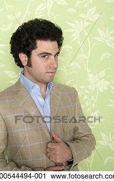 Stock Photography - stylish man wearing 
suit jacket,  
against wallpaper 
background. fotosearch 
- search stock 
photos, pictures, 
images, and photo 
clipart