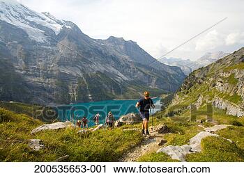 Stock Photography - switzerland, kandersteg, 
five hikers near 
lake oeschinensee. 
fotosearch - search 
stock photos, 
pictures, images, 
and photo clipart