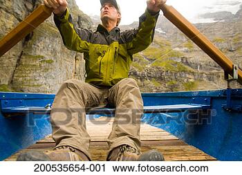 Stock Photography - switzerland, kandersteg, 
lake oeschinensee, 
mature man in 
rowboat. fotosearch 
- search stock 
photos, pictures, 
images, and photo 
clipart