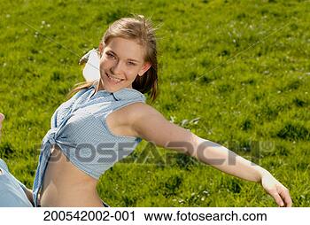 Stock Photography - teenage boy (16-18) 
holding up teenage 
girl (15-17) in 
field, smiling. 
fotosearch - search 
stock photos, 
pictures, images, 
and photo clipart