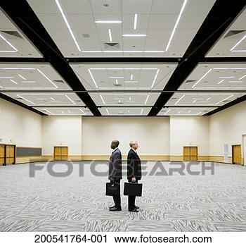 Stock Photography - two businessmen 
standing back 
to back in empty 
auditorium, side 
view. fotosearch 
- search stock 
photos, pictures, 
images, and photo 
clipart