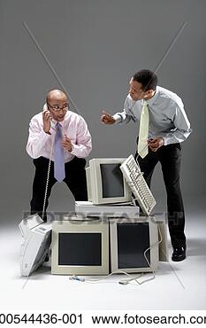 Stock Photography - two businessmen 
standing over 
pile of old technology, 
 trying to. fotosearch 
- search stock 
photos, pictures, 
images, and photo 
clipart