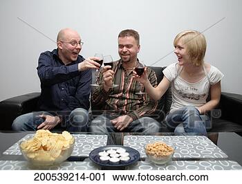 Stock Photography - two men and young 
woman toasting 
glasses of red 
wine, smiling. 
fotosearch - search 
stock photos, 
pictures, images, 
and photo clipart