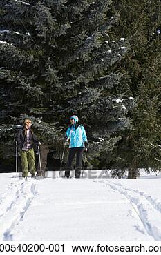 Stock Photography - two women cross-country 
skiing. fotosearch 
- search stock 
photos, pictures, 
images, and photo 
clipart